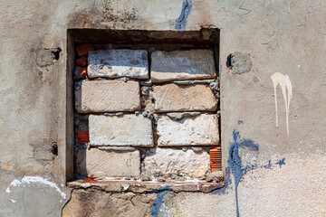 Window tightly closed with bricks . No light through the window . Brick masonry