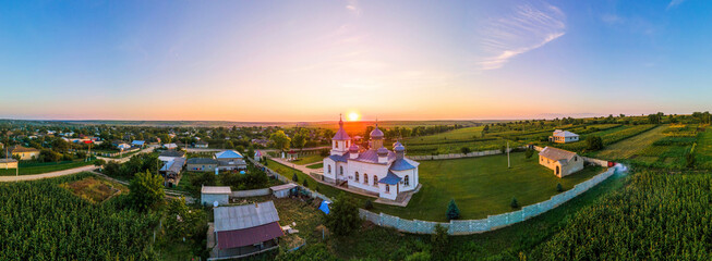 Aerial drone panorama view of country church in Moldova at sunset
