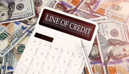 LINE OF CREDIT text on display calculator on dollars background
