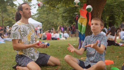 The male teacher shows his skills in the camp. Juggling can help keep physically fit and mentally...