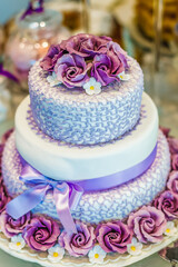 wedding cake decorated with violet flowers