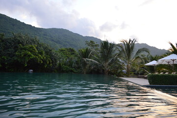 Dark turquoise water pool and pool bar area of a remote resort in Con Dao Islands, Vietnam. 