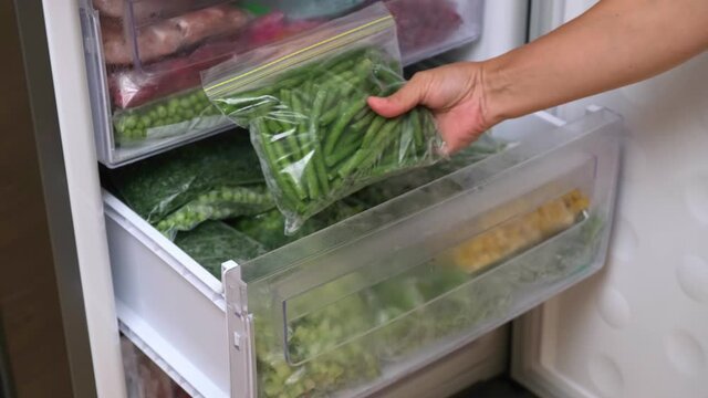 Frozen green beans. Frozen food storage. A raw food diet. Plastic bags with sliced vegetables and fruits