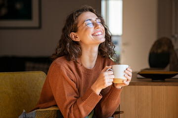 Cheerful woman enjoying coffee cup in a winter afternoon - 457504109