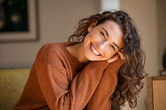Young woman laughing while relaxing at home