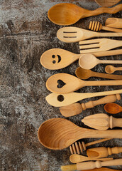 beautiful wooden spoons and utensils on stone surface
