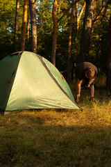 man sets up a tent