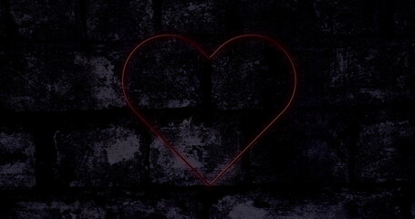 Image of red neon heart flashing on dark brick wall