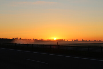 city. sunrise sun. expressway. fog. close-up. there is a tinting.