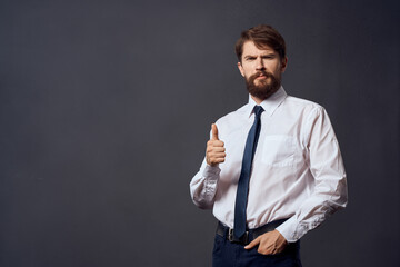 The man in a suit emotions hand gestures dark background