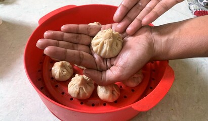 Modak making or preparation. Modak is Maharashtrian sweet dish made especially during festival of Ganesh Chaturthi. It is a made dumpling of rice 0r wheat flour filled with grated coconut and Jaggery.