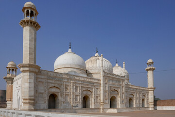 Fototapeta na wymiar Side view of beautiful white marble Abbasi mughal style mosque outside Derawar fort in Cholistan desert, Bahawalpur, Punjab, Pakistan