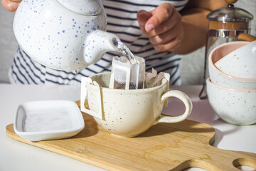 Making instant brewed cup of drip coffee