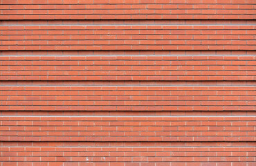 Brick wall constructed of red brick.