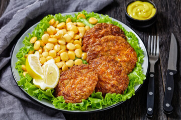 baked pork patties with lupin beans on a plate