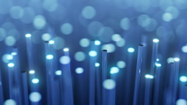 Optical fibers transferring light signal for high speed internet connection in slow motion. Close up with blurred out of focus objects due to depth of field.