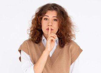 Pretty girl making silence gesture over white background