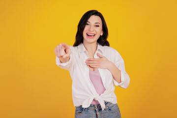 Portrait of funny charming girl hand chest direct finger you laugh on yellow background