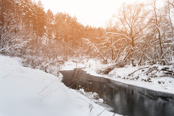 Winter landscape with river and coniferous forest