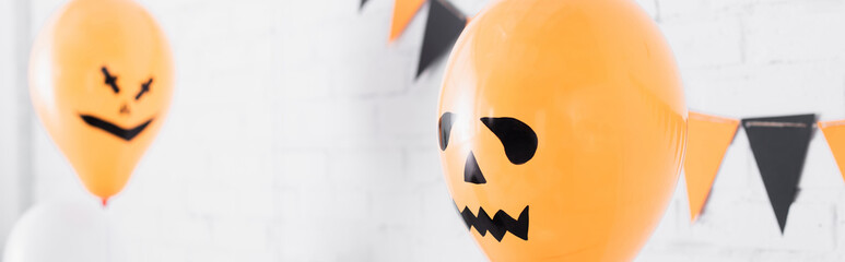 spooky orange balloons on halloween party, banner