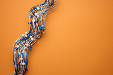 orange background with wooden blue decor branch. Backdrop for product demonstration, for writing