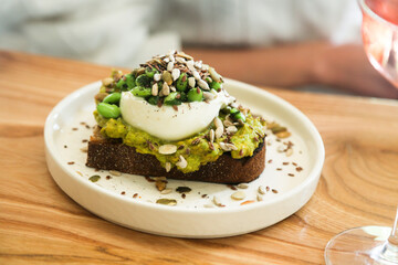 Healthy avocado toast with cheese and seeds