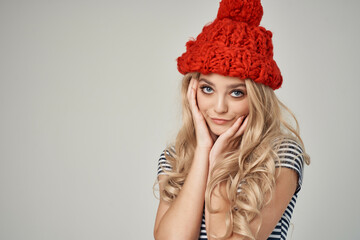 pretty woman in a striped T-shirt Red Hat light background Lifestyle