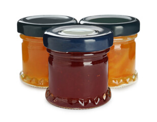 Jars with different jams on white background