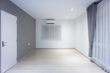 Empty room or bedroom in perspective at night. Interior inside house building consist of wooden laminate floor, white gray wall, window, curtains and light. New and clean look modern for background.