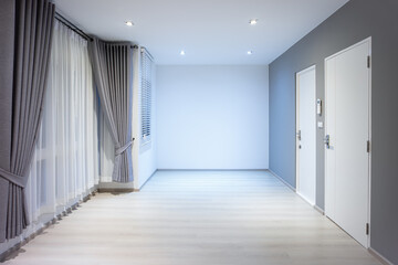 Empty room or bedroom in perspective at night. Interior inside house building consist of wooden laminate floor, white gray wall, window, curtains and light. New and clean look modern for background.