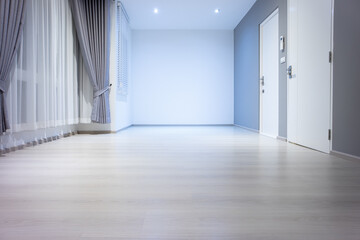 Empty room or bedroom in perspective at night. Interior inside house building consist of wooden laminate floor, white gray wall, window, curtains and light. New and clean look modern for background.