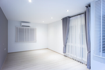 Empty room or bedroom at night. Interior inside house consist of wooden laminate floor, white gray...