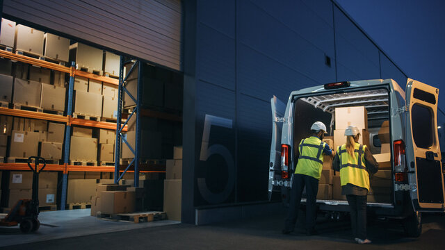 Outside of Logistics Distributions Warehouse Diverse Team of Workers Loading Delivery Truck with Cardboard Boxes. Online Orders, Purchases, E-Commerce Goods, Supply Chain. Evening Shot