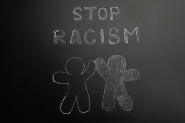 Chalked inscription Stop Racism and people figures on blackboard