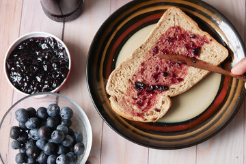 blue berry jam on bread on table,