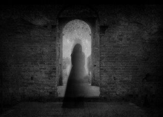 A spooky ghost of a woman in a dress, back to camera, framed by the archway of an old building. With a grunge, vintage, blurred edit.