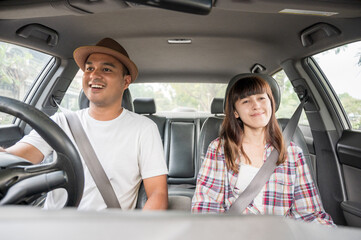 Front view young asian couple happiness and smiling sitting in car. Travel concept, Safety first insurance concept