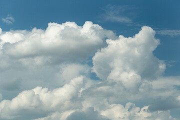 Naklejka na ściany i meble Cumuliform cloudscape on sky. Panorama. The sun is hidden. Cumulonimbus clouds.