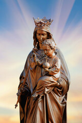 Queen of Heaven. Ancient statue of the Virgin Mary with Jesus Christ. Vertical image.