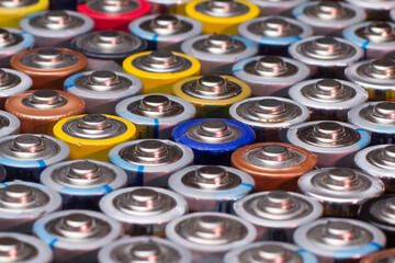 multiple stacked aaa batteries of different color and manufacturer