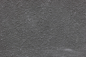 Concrete putty texture. Plaster on the wall. Rough granular surface. The surface is gray.