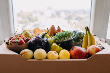 Box full of various organic fruits and vegetables. Food delivery concept.
