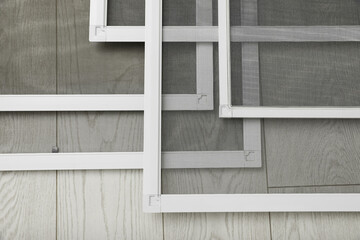 Set of window screens on wooden floor, closeup
