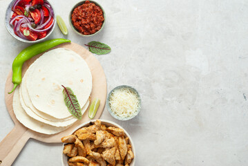 Mexican shredded chicken tacos with ingredients with copy space