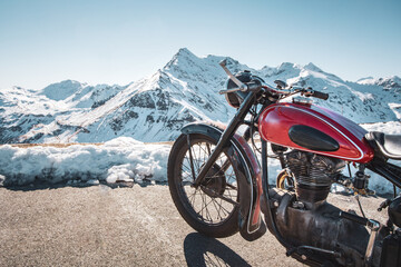 Classic vintage motorbike parking on a mountain road - obrazy, fototapety, plakaty