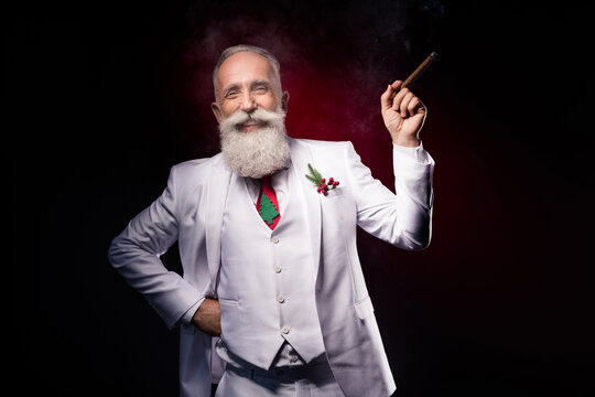 Photo of aged handsome man happy positive smile confident rich smoking addict isolated over dark color background