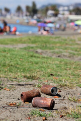 Travelers or tourists dropped cans, very rusty like polluted trash on the beach long ago. Tin can damage and rust.