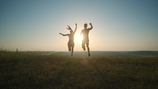 The man and woman jogging on scenic river background. slow motion