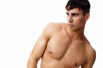 Fototapeta premium sexy guy athlete with a pumped-up torso nude model light background