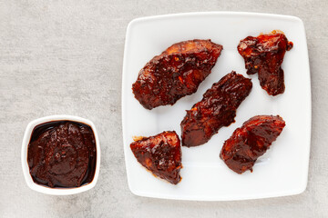 Meat marinated in adobo sauce. Raw turkey breast piece in brown chili marinade.